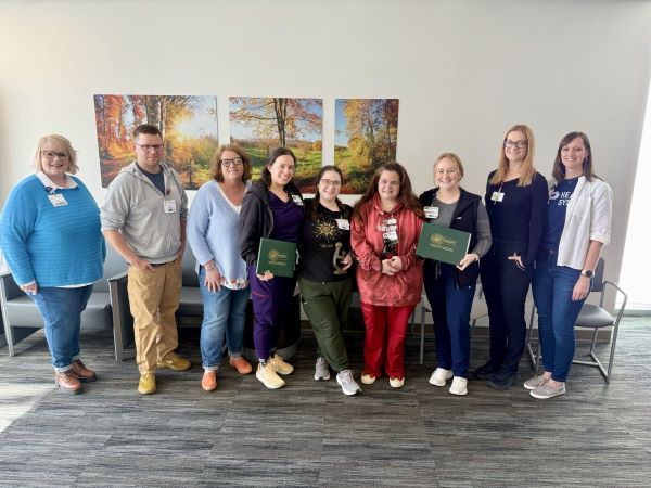 Olivia and Jennifer with several members of the staff on the Behavioral Health Unit