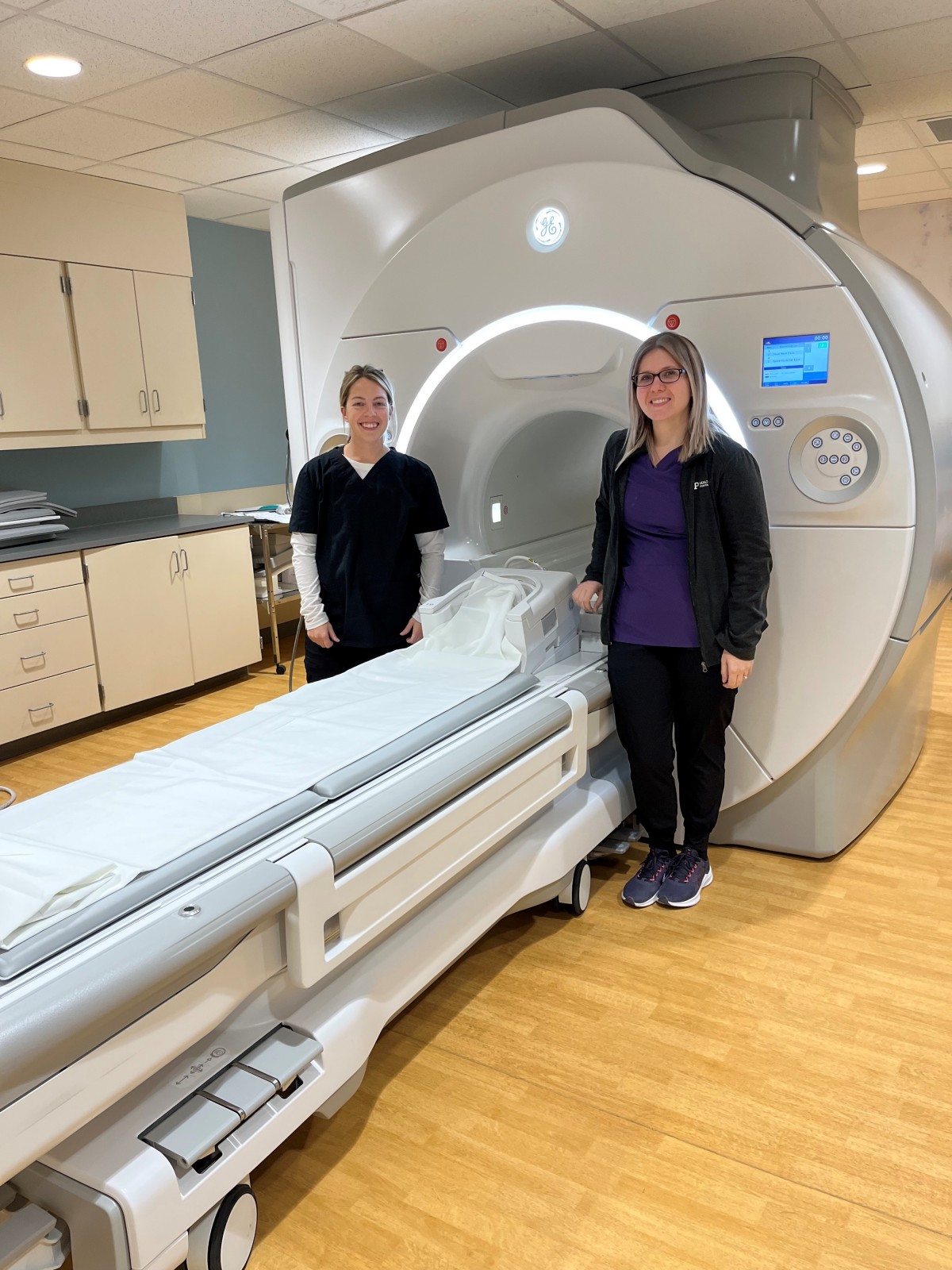UPHS - Portage MRI Technologists Ashley Reuter (L) and Crystal Ricklard are shown with the new MRI scanner.